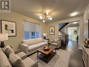 Caledon apartment for rent - A living room with a couch, a coffee table, and a lamp.