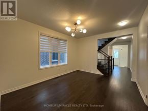 Caledon apartment for rent - A spacious room with wooden floors and a staircase.