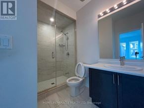 Caledon apartment for rent - A bathroom with a toilet, sink, and shower.