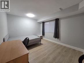 Coquitlam apartment for rent - A bedroom with a bed, desk, and chair.