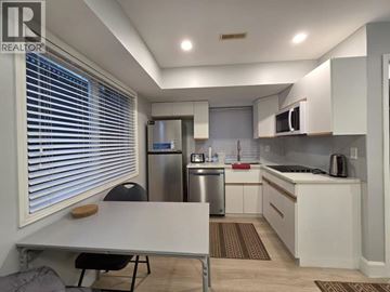 Coquitlam apartment for rent - A kitchen with white cabinets and a stainless steel refrigerator.