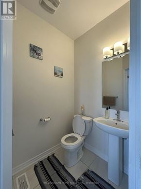 Barrie townhouse for rent - A white toilet and sink in a small bathroom.