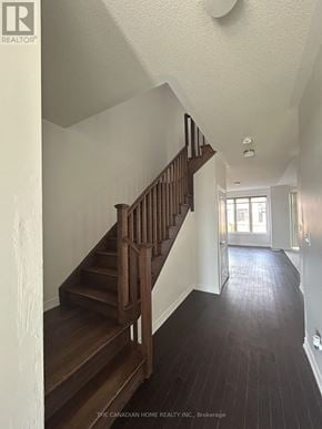 Barrie townhouse for rent - A staircase with a wooden handrail and steps leads to a doorway.
