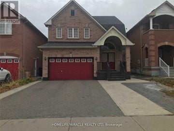 Brampton (Bram East) apartment for rent - A brick house with a red garage door is for sale.