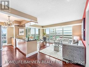 Toronto (Willowdale East) condo for rent - A well-lit living room with a kitchen area in the background.