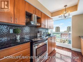 Toronto (Willowdale East) condo for rent - A kitchen with wooden cabinets and a stove top oven.