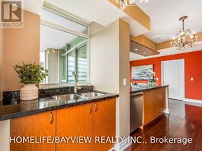 Toronto (Willowdale East) condo for rent - A kitchen with a sink, a plant, and a chandelier.