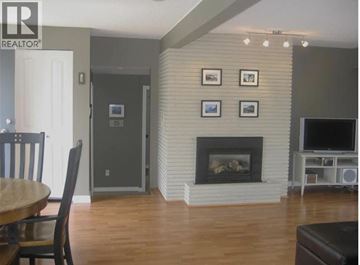 Coquitlam apartment for rent - A living room with a fireplace and a television.