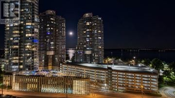 Toronto (Waterfront Communities) condo for rent - A spacious living room with a large window, a sofa set, and a coffee table.