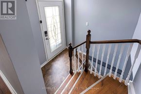 Wasaga Beach apartment for rent - A staircase with a white railing and a wooden handrail.