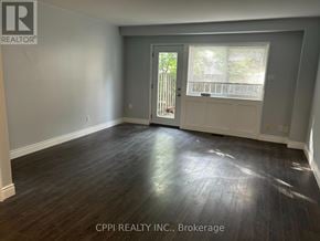 Toronto (Don Valley Village) townhouse for rent - A room with a wooden floor and a door leading outside.