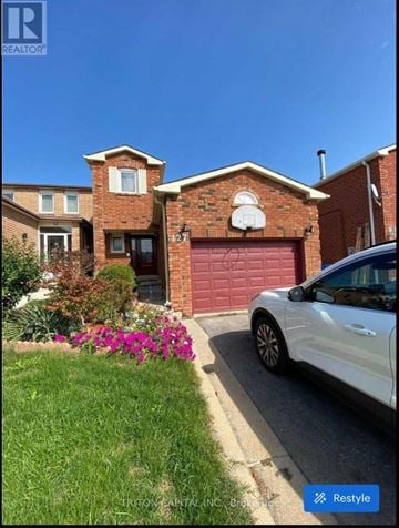 Vaughan (West Woodbridge) apartment for rent - A white car is parked in front of a red garage.