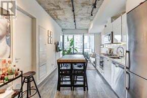 Toronto (Moss Park) condo for rent - A kitchen with a table and chairs in the middle of it.