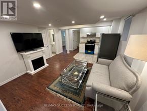 Milton (Ha Harrison) apartment for rent - A living room with a fireplace and a television.