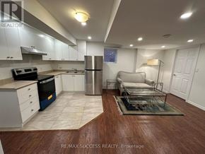 Milton (Ha Harrison) apartment for rent - A kitchen with a refrigerator, stove, and sink.