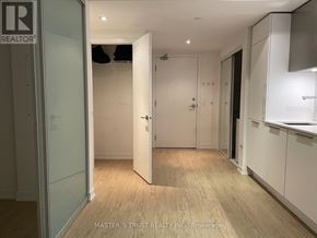 Toronto (Church-Yonge Corridor) condo for rent - A room with a wooden floor and white walls, with a glass door leading to another room.