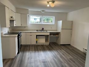 Surrey apartment for rent - A kitchen with a black dishwasher and white cabinets.