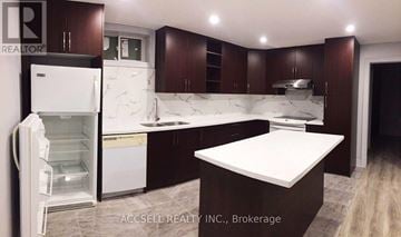 Markham (Village Green-South Unionville) apartment for rent - A kitchen with brown cabinets and a white island.