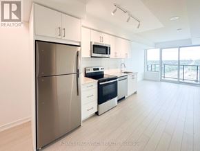 Toronto (Humber Heights) condo for rent - A modern kitchen with a stainless steel refrigerator, microwave, oven, and dishwasher.