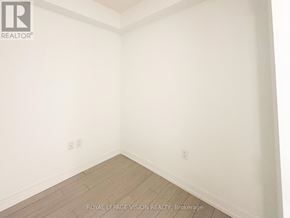 Toronto (Humber Heights) condo for rent - A white room with a wooden floor and a wall with a switch.