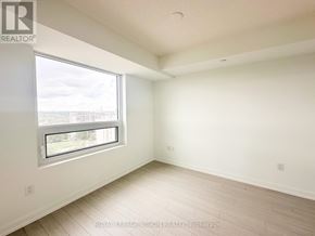 Toronto (Humber Heights) condo for rent - A white room with a window and wooden flooring.