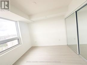 Toronto (Humber Heights) condo for rent - A white room with a sliding glass door and a window.