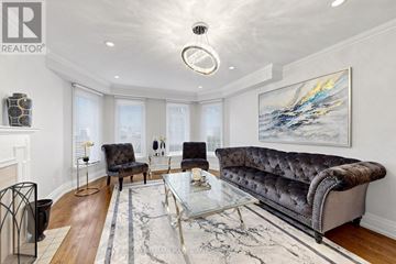 Aurora (Aurora Highlands) apartment for rent - A living room with a grey sofa, a glass coffee table, and a painting on the wall.