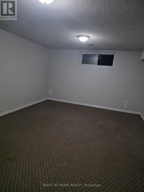 Toronto (Thistletown-Beaumonde Heights) apartment for rent - A room with a carpeted floor and a window.