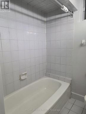 Toronto (Thistletown-Beaumonde Heights) apartment for rent - A white bathroom with a white tub and white tiles.