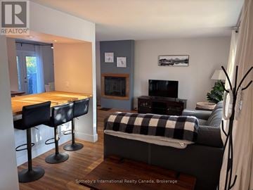 Collingwood apartment for rent - A living room with a grey couch and a black and white checkered blanket.