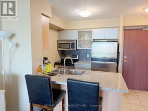 Toronto (Willowdale East) condo for rent - A kitchen with a sink, microwave, and oven.