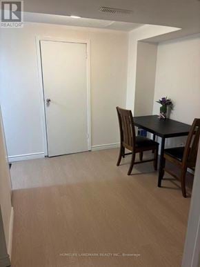 Toronto (L'amoreaux) townhouse for rent - A room with a table and chairs and a door.