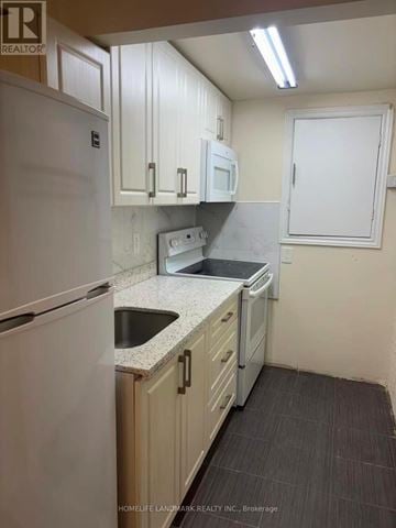 Toronto (L'amoreaux) townhouse for rent - A kitchen with white appliances and cabinets.