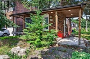 Toronto (Birchcliffe-Cliffside) apartment for rent - A house numbered 29 with a red door is surrounded by greenery.