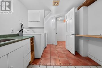 Toronto (Birchcliffe-Cliffside) apartment for rent - A kitchen with white cabinets and a green counter top.