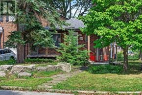 Toronto (Birchcliffe-Cliffside) apartment for rent - A red brick house with a white car parked in front.