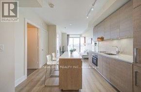 Toronto (Annex) condo for rent - A modern kitchen with wooden floors and cabinets.