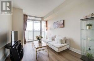Toronto (Annex) condo for rent - A living room with a white couch and a glass coffee table.