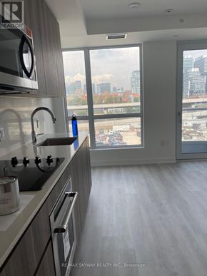 Toronto (Waterfront Communities) condo for rent - A modern kitchen with a view of the city skyline.