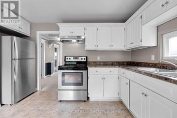 London East (East F) apartment for rent - A kitchen with a stainless steel refrigerator and white cabinets.
