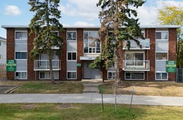 Edmonton apartment for rent - Apartment building with a green sign in front.