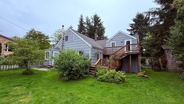 Sitka apartment for rent - A house with a grey roof and a deck.
