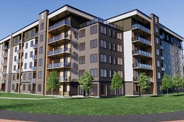 Dieppe apartment for rent - A large apartment building with balconies and trees in front.