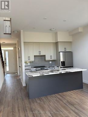 Blue Mountains apartment for rent - A modern kitchen with a large island and stainless steel appliances.