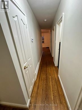 Toronto (Wexford-Maryvale) apartment for rent - A hallway with white walls and wood flooring.
