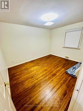Toronto (Wexford-Maryvale) apartment for rent - A room with wooden flooring and a window with blinds.