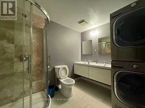 Toronto (Agincourt North) apartment for rent - A bathroom with a toilet, sink, and a washing machine.