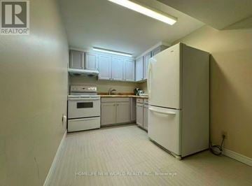Toronto (Agincourt North) apartment for rent - A kitchen with white appliances and cabinets.