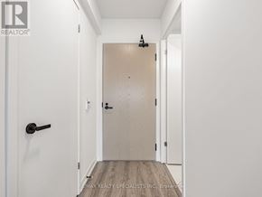 Vaughan (Vaughan Corporate Centre) condo for rent - A white door with a black handle is in a white hallway.