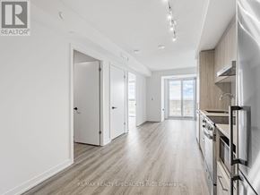 Vaughan (Vaughan Corporate Centre) condo for rent - A modern kitchen with white cabinets and a wooden floor.